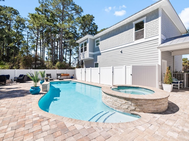 view of swimming pool with an in ground hot tub, a patio area, a fenced in pool, and a fenced backyard