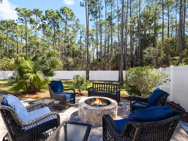 view of patio featuring a fenced backyard and an outdoor fire pit