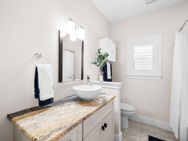 full bathroom with tile patterned flooring, toilet, vanity, and baseboards