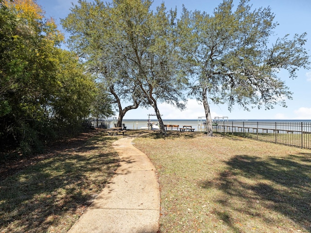 view of yard with a water view and fence