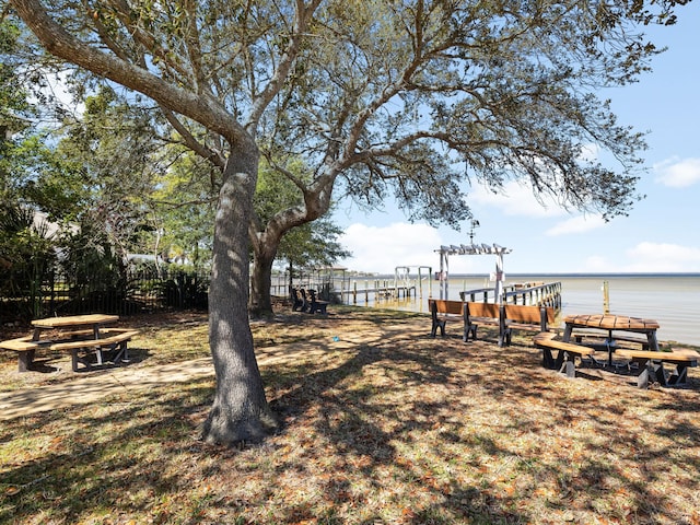 view of yard with fence and a water view