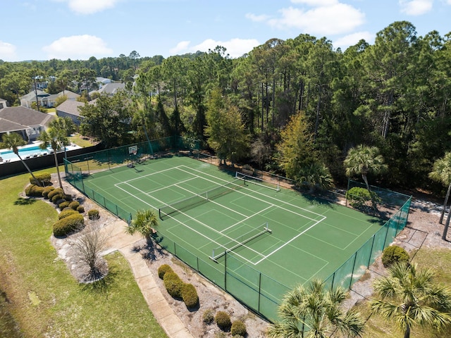 view of tennis court featuring fence