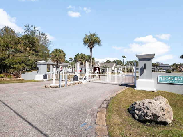 view of street with a gate and a gated entry