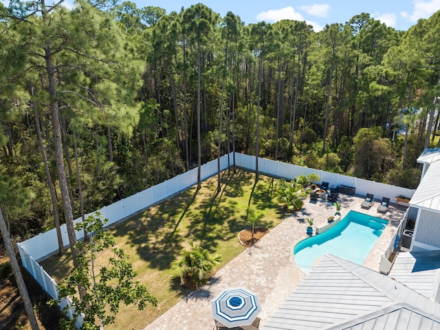 view of swimming pool with a patio area, a fenced in pool, a fenced backyard, and a lawn