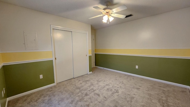 unfurnished bedroom featuring carpet flooring, visible vents, baseboards, a closet, and electric panel