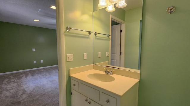 bathroom featuring baseboards and vanity