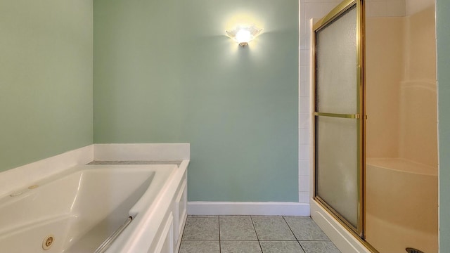 full bathroom featuring a stall shower, baseboards, a whirlpool tub, and tile patterned floors