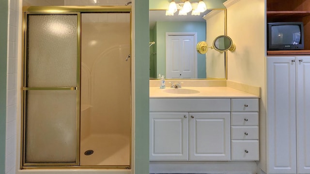 bathroom featuring a shower stall and vanity