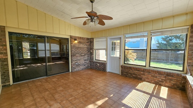 unfurnished sunroom featuring lofted ceiling and ceiling fan