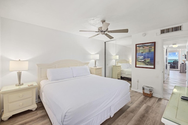 bedroom with ceiling fan, a closet, light wood-type flooring, and visible vents