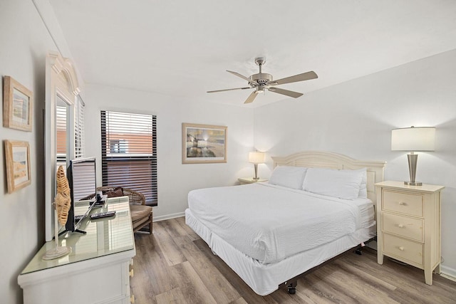 bedroom featuring light wood-type flooring, ceiling fan, and baseboards