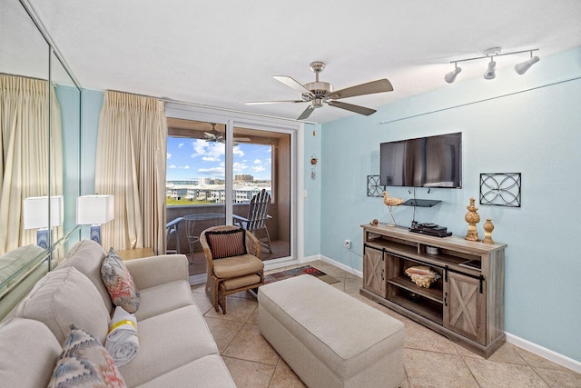 living room featuring light tile patterned floors, a ceiling fan, and baseboards