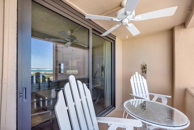 balcony featuring a sunroom and a ceiling fan