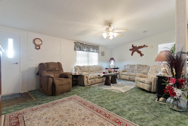 carpeted living room with a ceiling fan, visible vents, a textured ceiling, and tile patterned floors