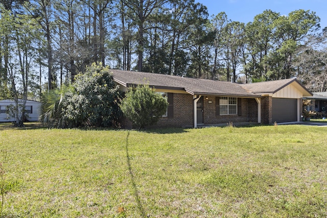 view of front of home featuring brick siding, driveway, a front lawn, and an attached garage