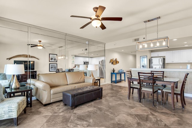 living area with visible vents and a ceiling fan