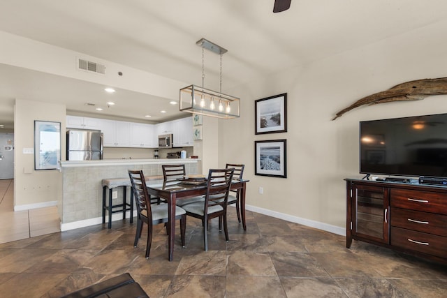 dining room with recessed lighting, visible vents, and baseboards