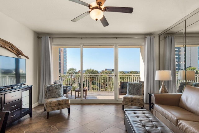 living area featuring a ceiling fan and tile patterned floors