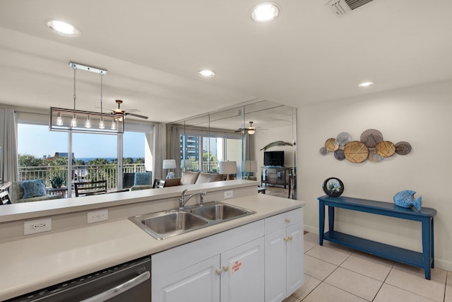 kitchen featuring stainless steel dishwasher, ceiling fan, plenty of natural light, and a sink