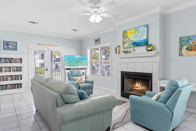 living room featuring visible vents, crown molding, and a fireplace