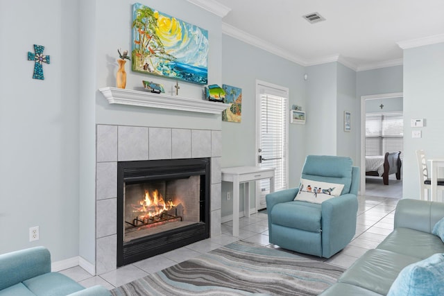 tiled living area featuring plenty of natural light, a tile fireplace, visible vents, and crown molding