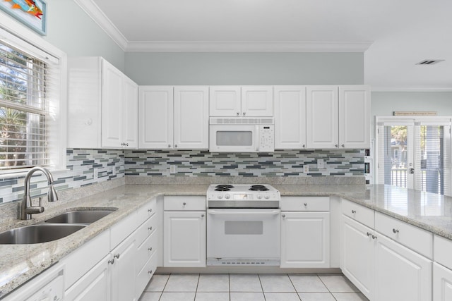 kitchen featuring light tile patterned flooring, white appliances, a sink, ornamental molding, and decorative backsplash