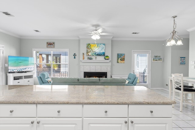 kitchen with a fireplace, visible vents, and open floor plan