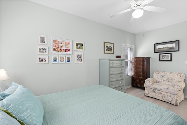 bedroom with light wood finished floors and a ceiling fan