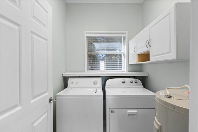 washroom with cabinet space and washing machine and clothes dryer