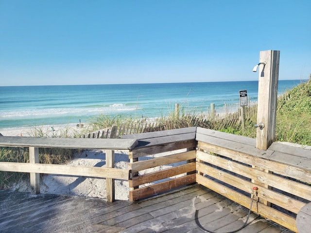 view of home's community featuring a water view and a beach view