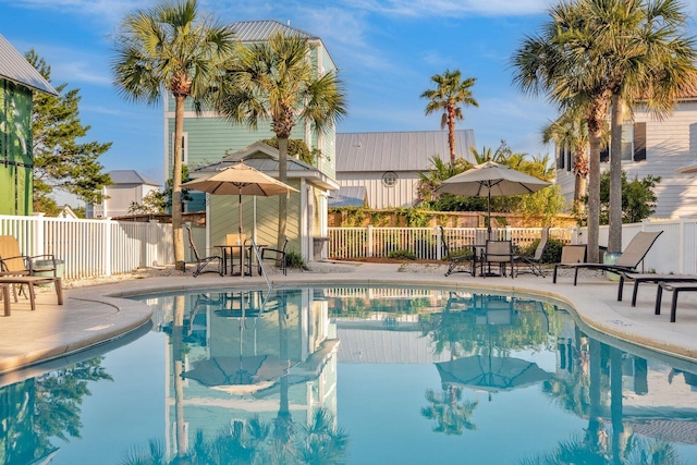 view of pool with a fenced in pool, fence, and a patio