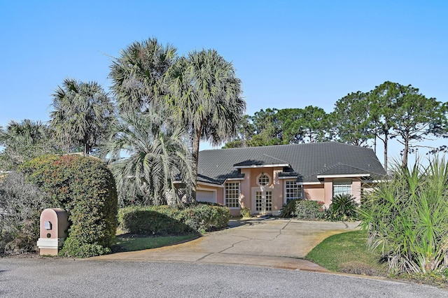 view of front of home featuring stucco siding, driveway, and an attached garage