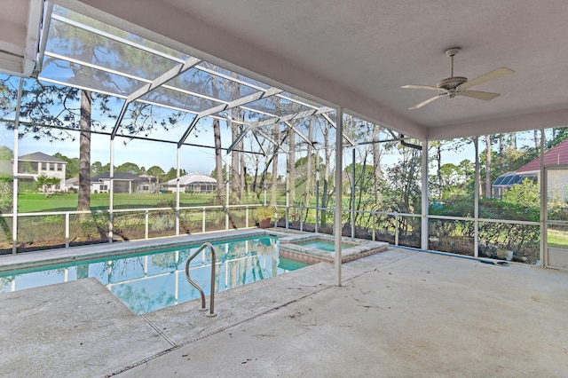 view of pool with glass enclosure, a pool with connected hot tub, and a patio