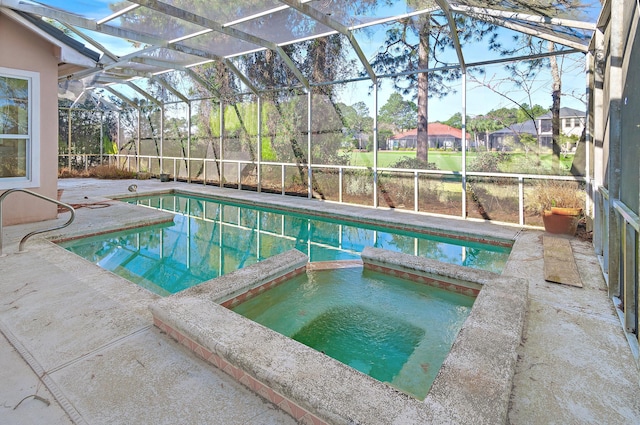 view of pool featuring a patio area, glass enclosure, and a pool with connected hot tub