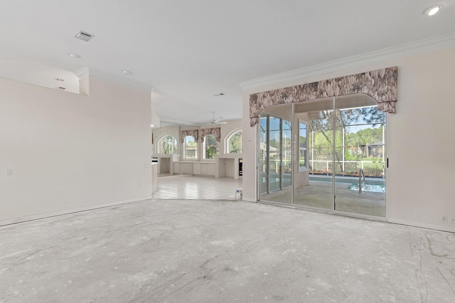 spare room featuring a ceiling fan, visible vents, and ornamental molding