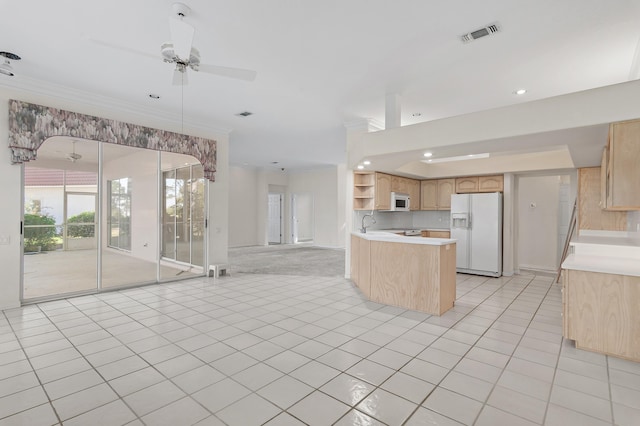 kitchen with light brown cabinets, open floor plan, white appliances, and visible vents