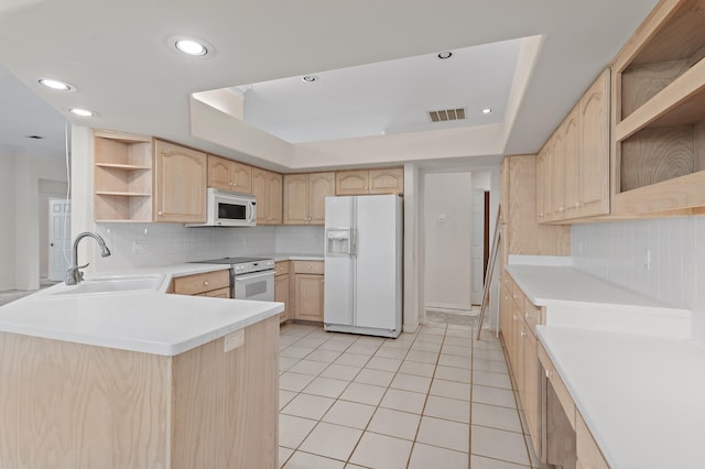 kitchen with light brown cabinetry, a sink, white appliances, and open shelves