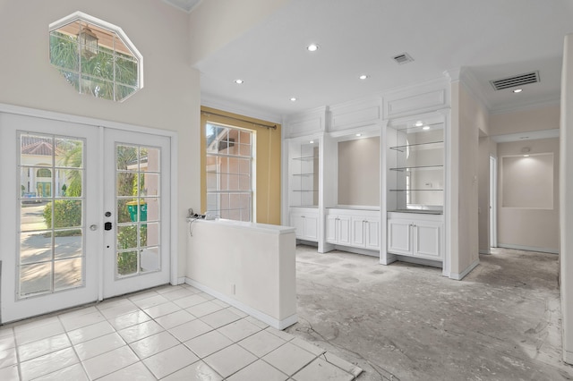 doorway to outside with crown molding, french doors, visible vents, and baseboards