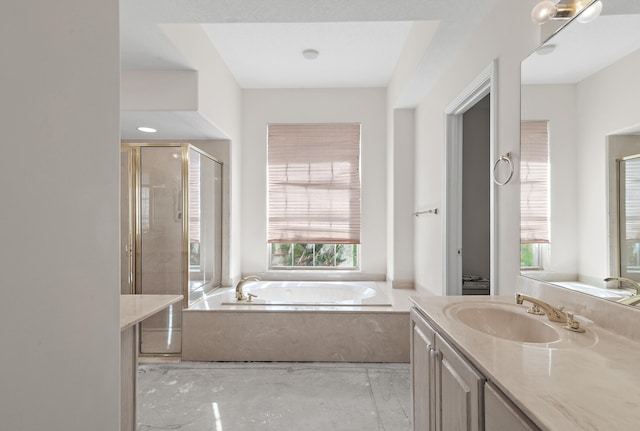 full bath with vanity, a garden tub, and a shower stall