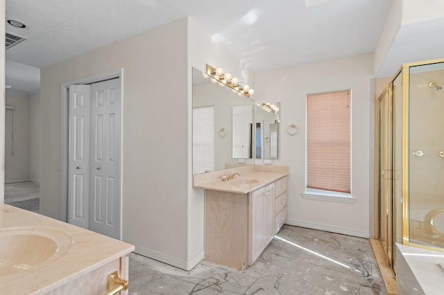 bathroom featuring visible vents, a shower stall, baseboards, two vanities, and a closet