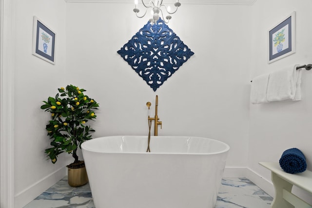 bathroom featuring a soaking tub, marble finish floor, and baseboards