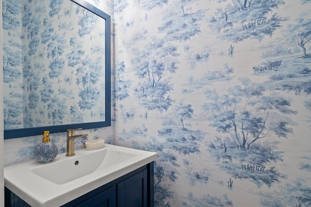 bathroom featuring wallpapered walls and vanity