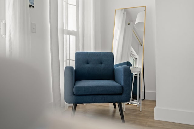 sitting room featuring baseboards and wood finished floors