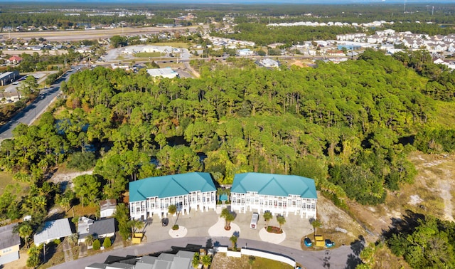 drone / aerial view featuring a wooded view