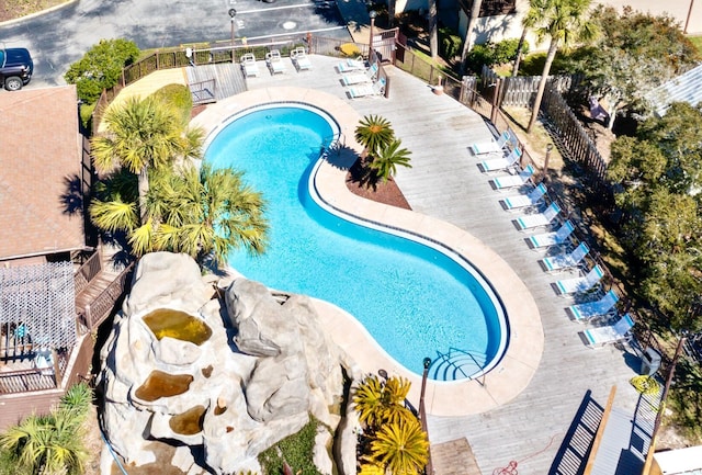 pool with fence and a patio