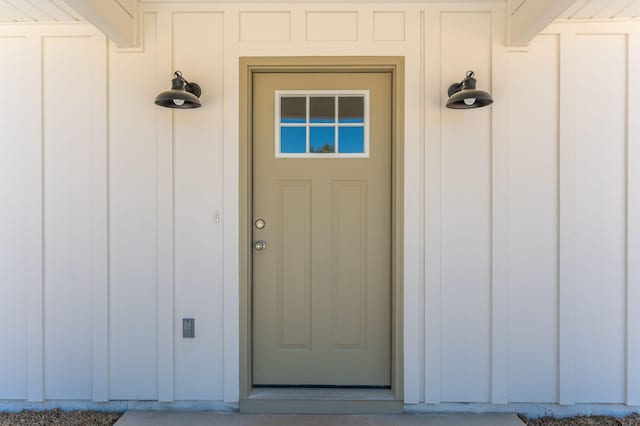 doorway to property featuring board and batten siding