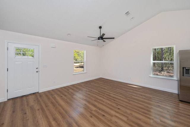 interior space with lofted ceiling, visible vents, ceiling fan, wood finished floors, and baseboards