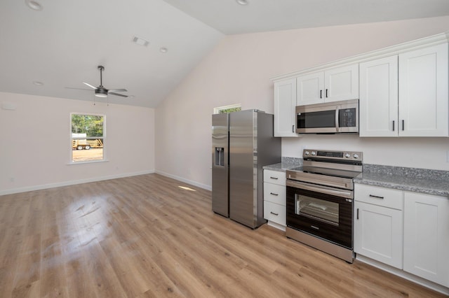 kitchen featuring visible vents, vaulted ceiling, stainless steel appliances, light wood-type flooring, and white cabinetry