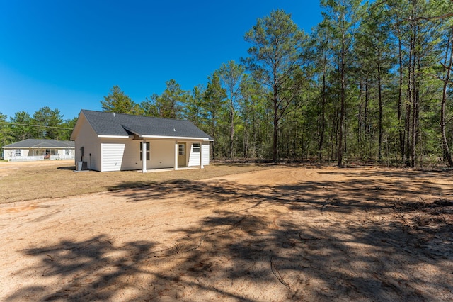 back of house with a shingled roof