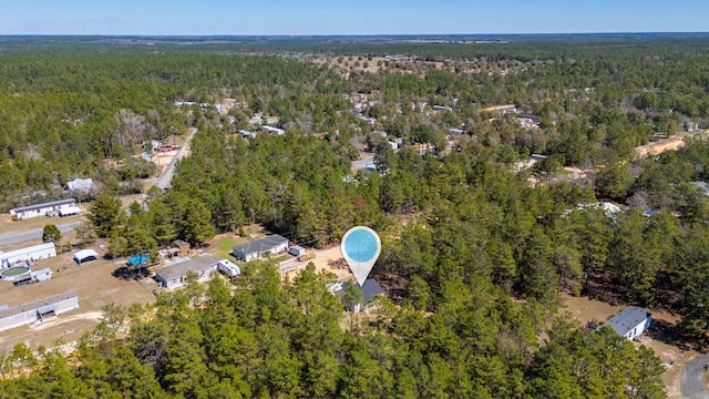 bird's eye view featuring a wooded view